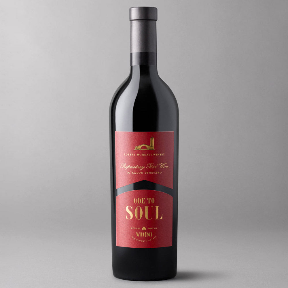 A bottle of Ode to Soul Red Wine with a black glass body, a dark gray capsule, and a red label featuring gold and white text. 