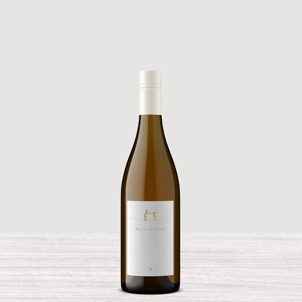 A single bottle of Harvey & Harriet White with a white label and a white capsule cap, centered against a white textured background.