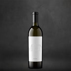 A bottle of My Favorite Neighbor Blanc on a textured gray background.