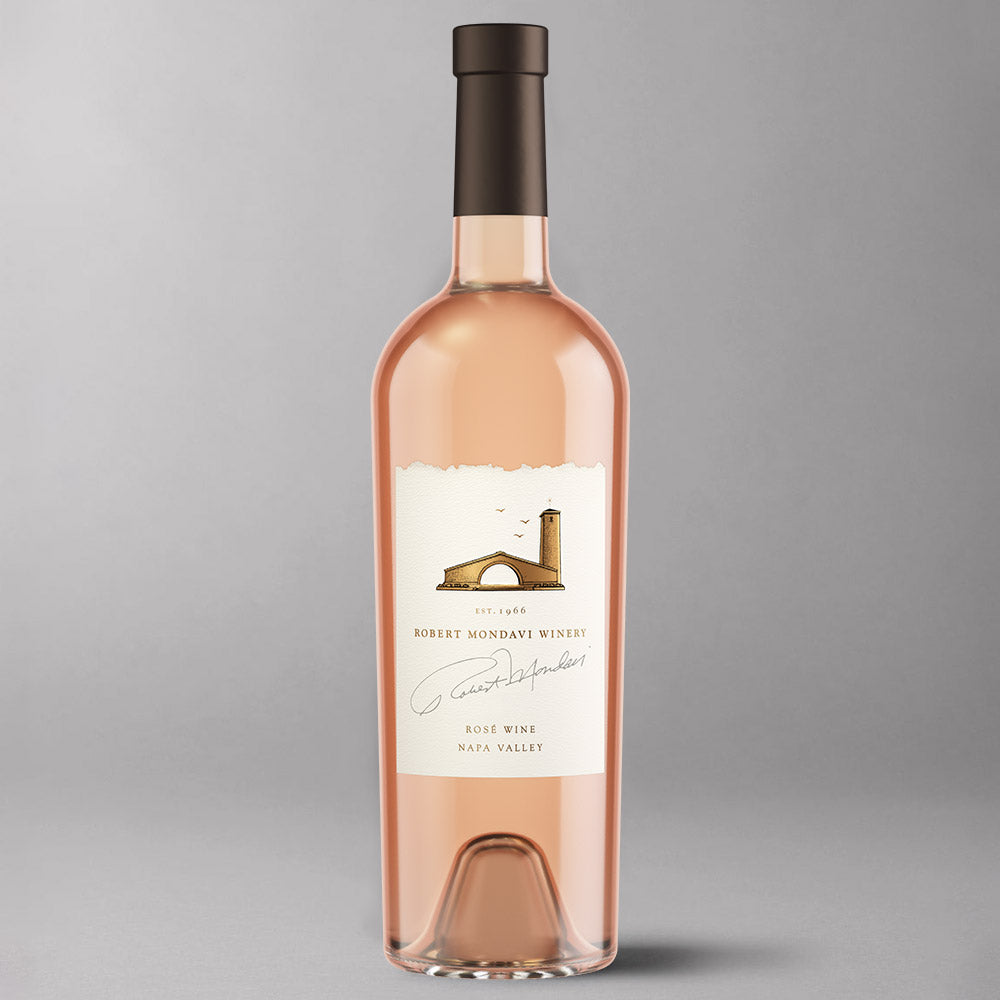 A bottle of Robert Monday Winery Rose Wine in a clear glass bottle, showing the pale pink color of the wine. The bottle has a cream-colored label and is set against a neutral gray background.