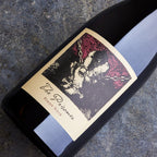 Wine bottle labeled 'The Prisoner' Pinto Noir on a textured surface